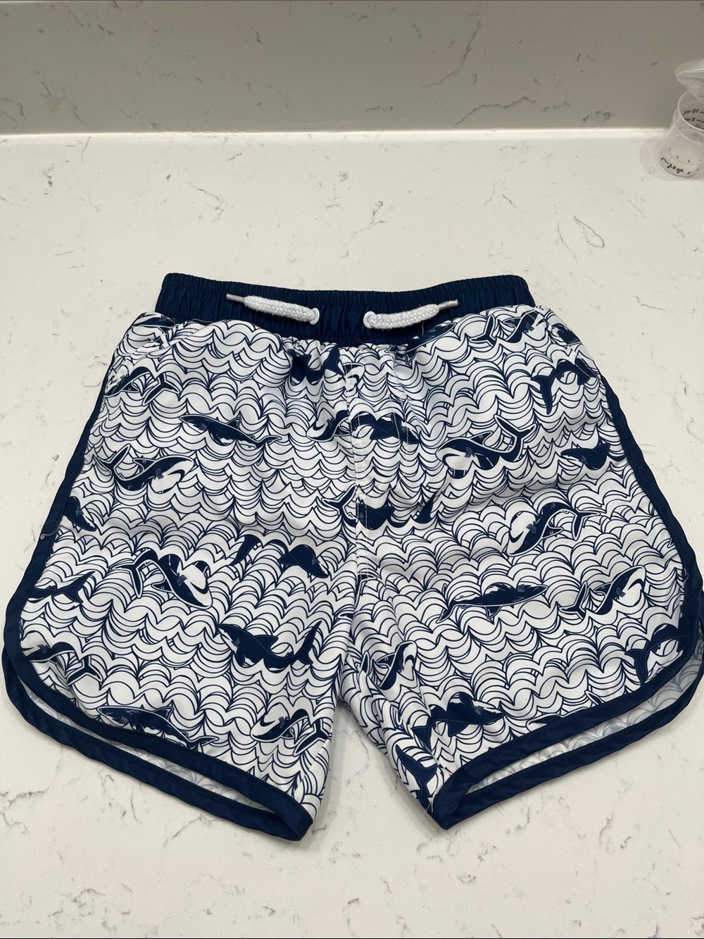 Kids Blue and White Wave-Print Swim Trunks